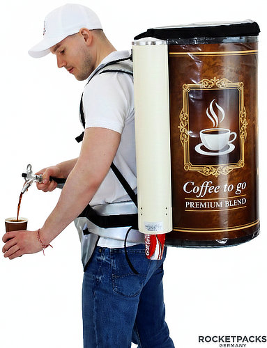 Promoter serving coffee into a paper cup using an insulated coffee dispensing backpack with an integrated tap and cup dispenser.
